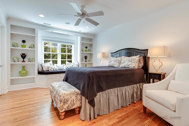 bedroom featuring ceiling fan, ornamental molding, and light wood-type flooring