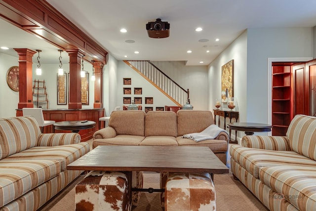 living room featuring light colored carpet and decorative columns