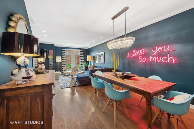 dining room featuring wood-type flooring and crown molding