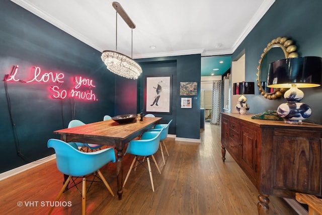 dining area with hardwood / wood-style flooring and ornamental molding