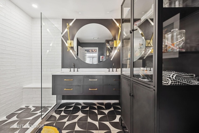 bathroom with vanity and a tile shower