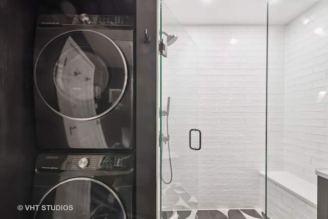 clothes washing area featuring stacked washer / dryer