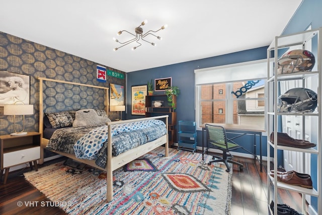 bedroom with dark wood-type flooring and a chandelier