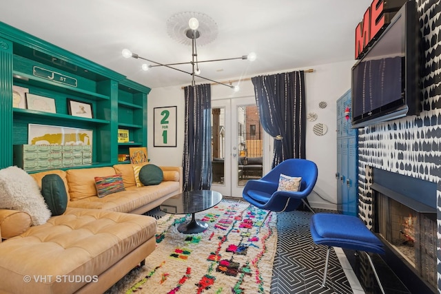 living room featuring a notable chandelier and french doors