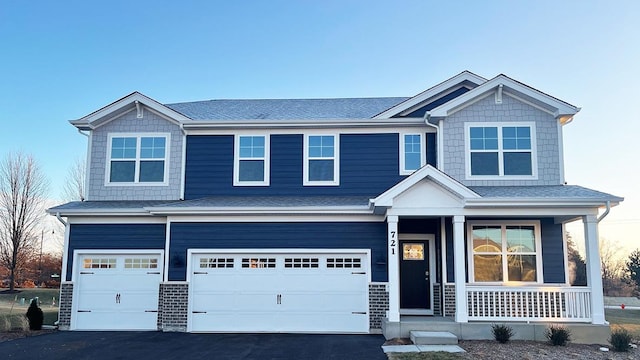 craftsman inspired home with a garage and a porch