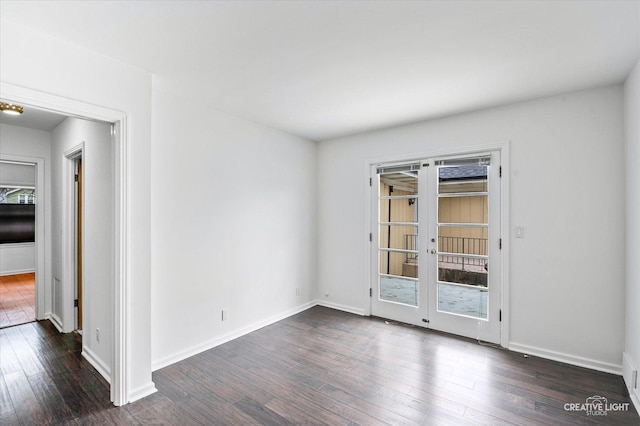 empty room featuring dark hardwood / wood-style floors and french doors