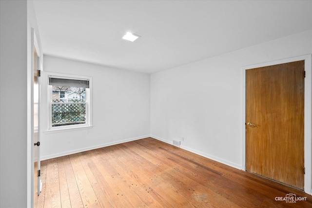 spare room with hardwood / wood-style flooring