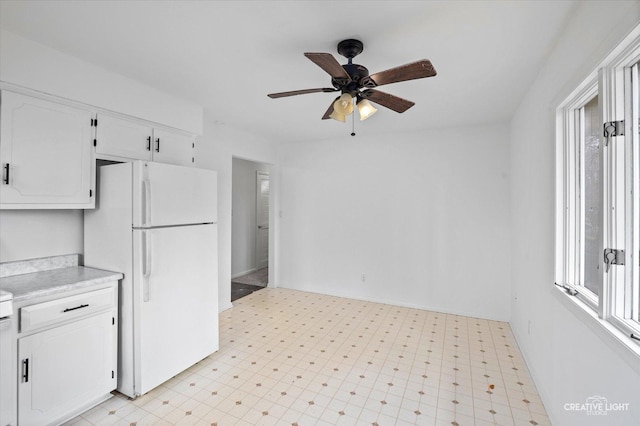 kitchen featuring ceiling fan, white cabinets, and white fridge