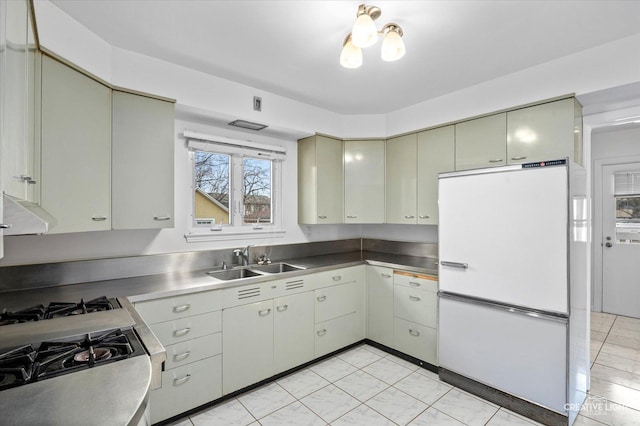 kitchen featuring white refrigerator and sink