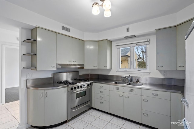 kitchen with sink, stainless steel range with gas cooktop, and gray cabinets