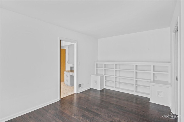 empty room with dark wood-type flooring