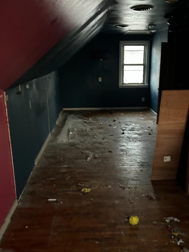 additional living space featuring lofted ceiling