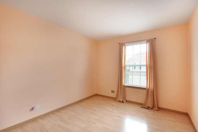 spare room featuring light hardwood / wood-style flooring