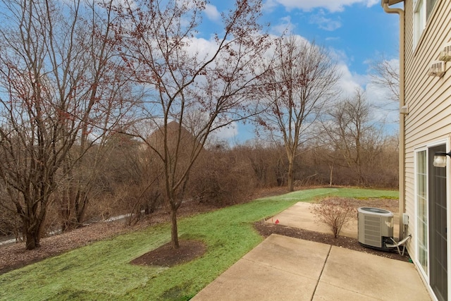 view of yard featuring central AC unit and a patio