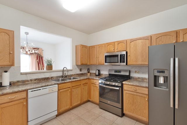 kitchen with light tile patterned flooring, appliances with stainless steel finishes, sink, backsplash, and a chandelier