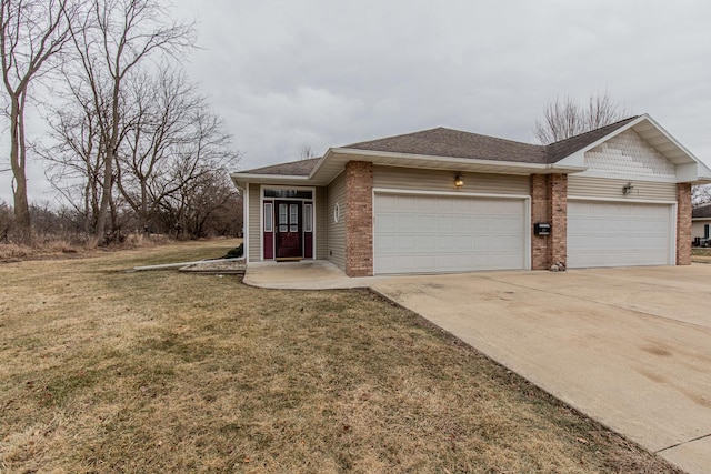 view of front of property with a garage and a front lawn