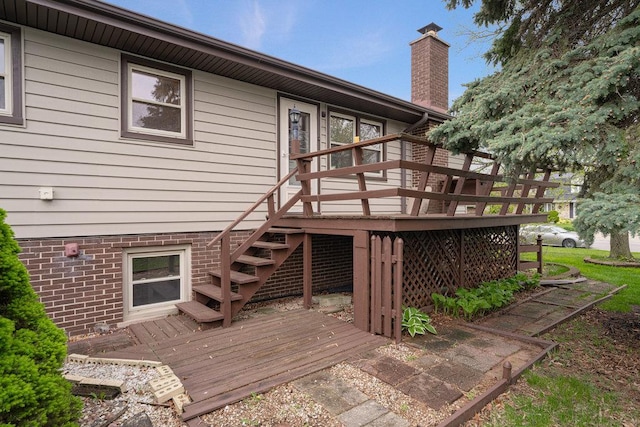 rear view of house featuring a wooden deck