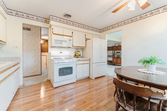 kitchen featuring white cabinetry, ceiling fan, light wood-type flooring, and white appliances