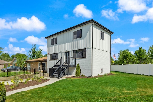 4932 Brummel St, Skokie, IL 60077 - rear view of house with brick siding, board and batten siding, and a fenced backyard