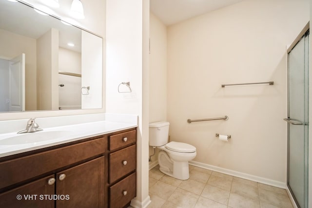 bathroom with vanity, tile patterned floors, toilet, and walk in shower