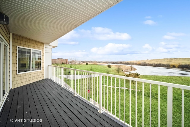 wooden deck featuring a lawn