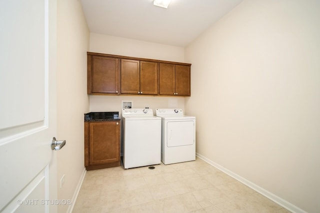 washroom featuring cabinets and washer and dryer