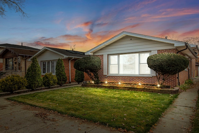 ranch-style house with a lawn