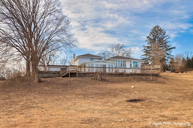 rear view of house featuring a deck