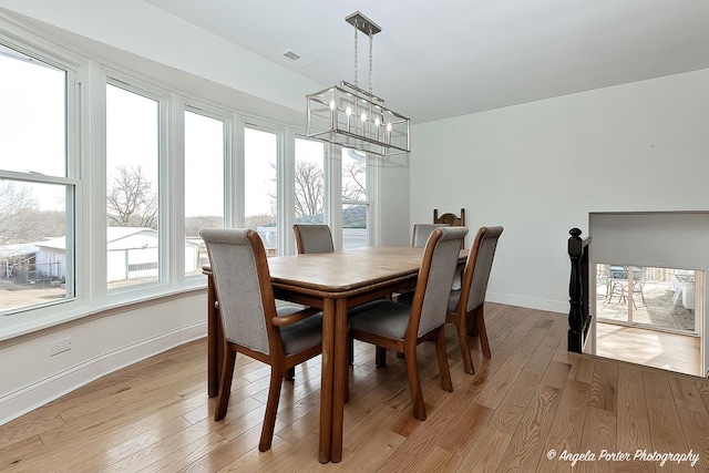 dining room featuring a notable chandelier and light hardwood / wood-style floors