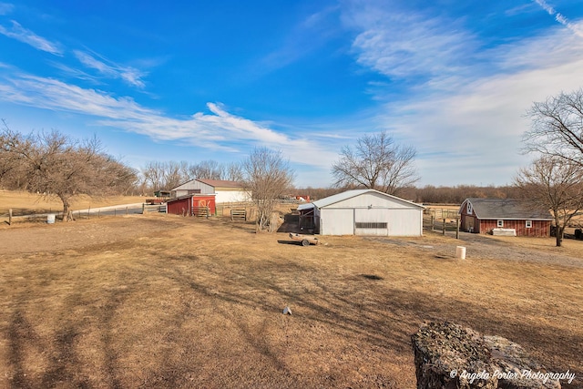 view of yard with an outdoor structure and a rural view