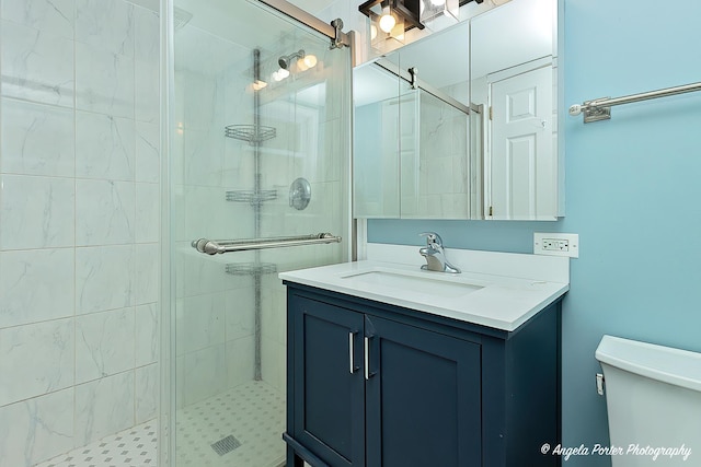 bathroom with vanity, toilet, and walk in shower