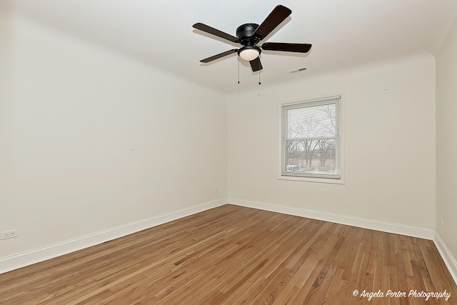 unfurnished room with ceiling fan and hardwood / wood-style floors