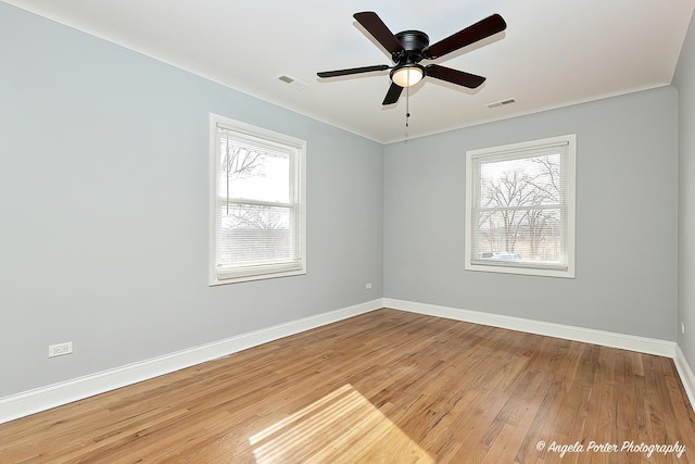 unfurnished room with ceiling fan and wood-type flooring