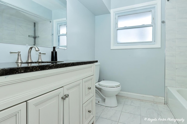 full bathroom with vanity, tiled shower / bath, and toilet