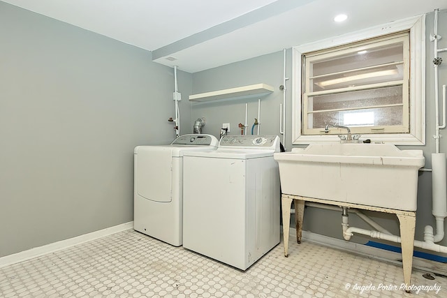 washroom with sink and washer and dryer