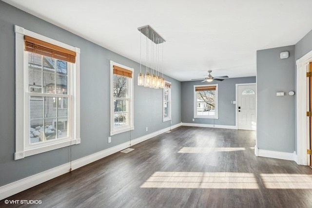 unfurnished dining area featuring dark hardwood / wood-style flooring and ceiling fan