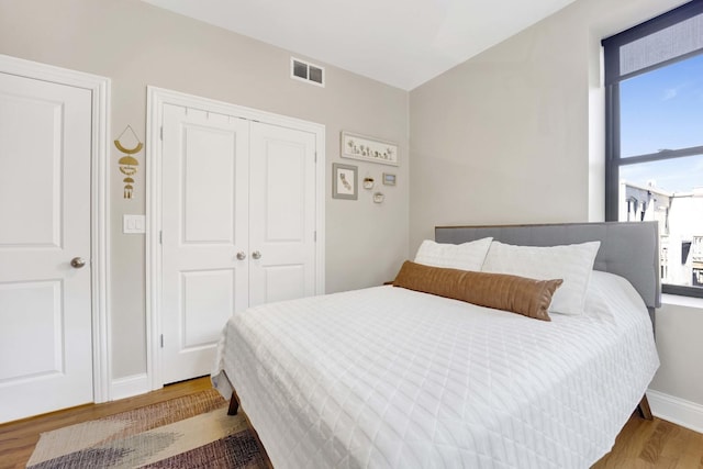 bedroom with hardwood / wood-style floors and a closet