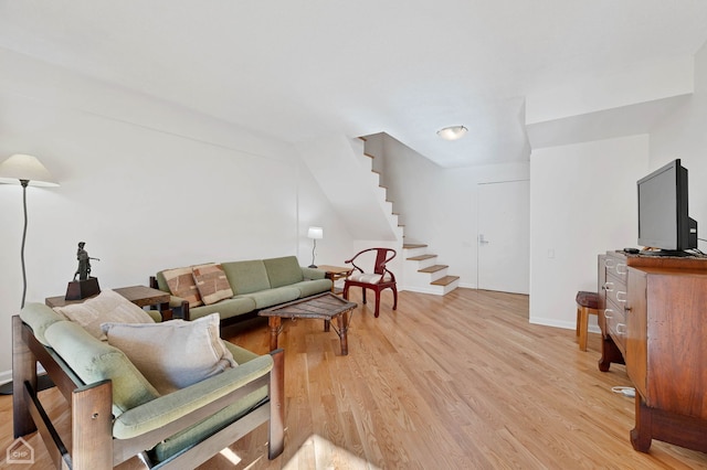 living room with lofted ceiling and light wood-type flooring