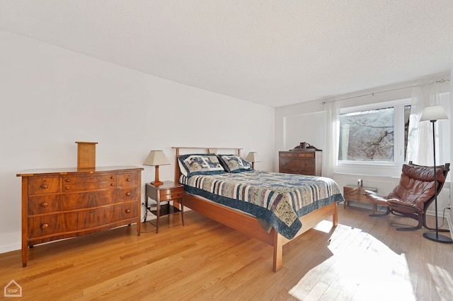 bedroom with light hardwood / wood-style flooring