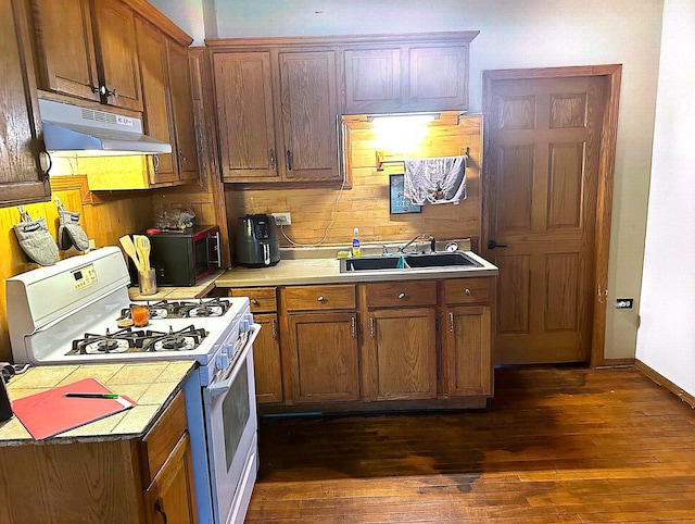 kitchen with sink, white range with gas stovetop, and dark hardwood / wood-style floors