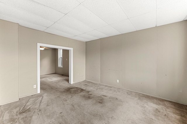 unfurnished room with a drop ceiling and light carpet