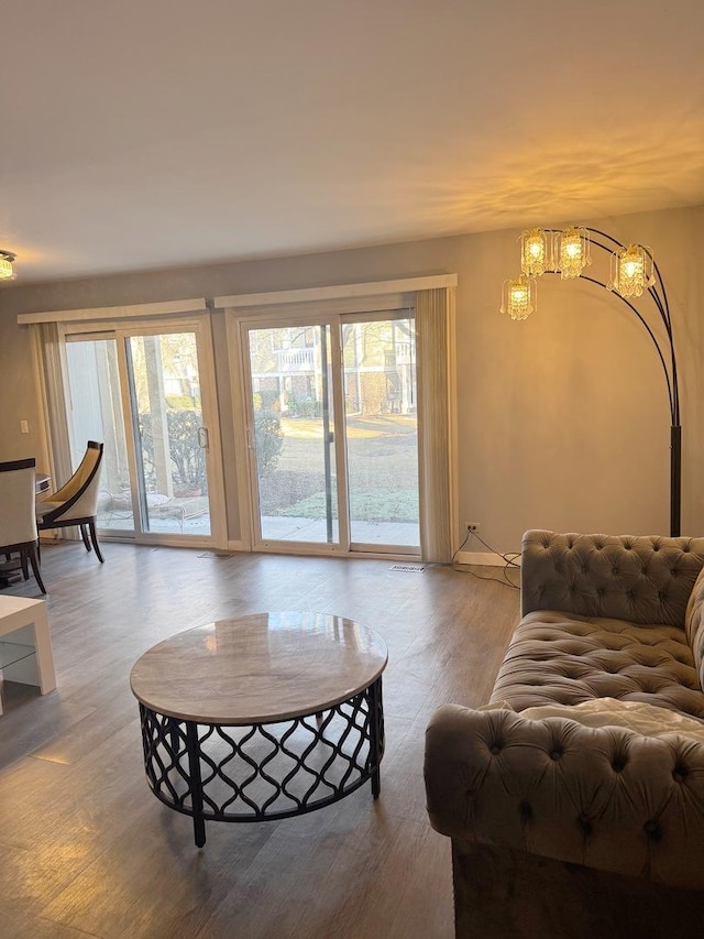 living room featuring an inviting chandelier and hardwood / wood-style floors