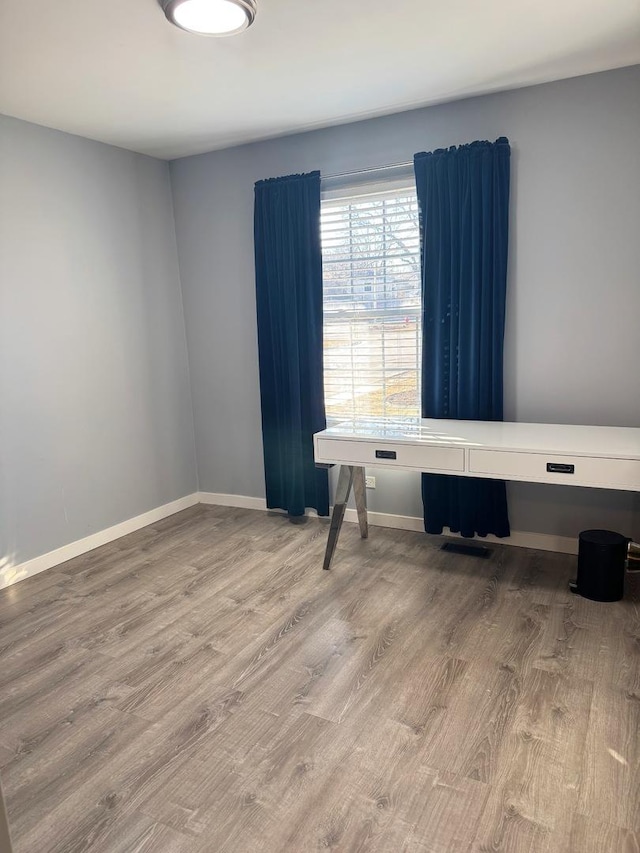 unfurnished room with hardwood / wood-style flooring