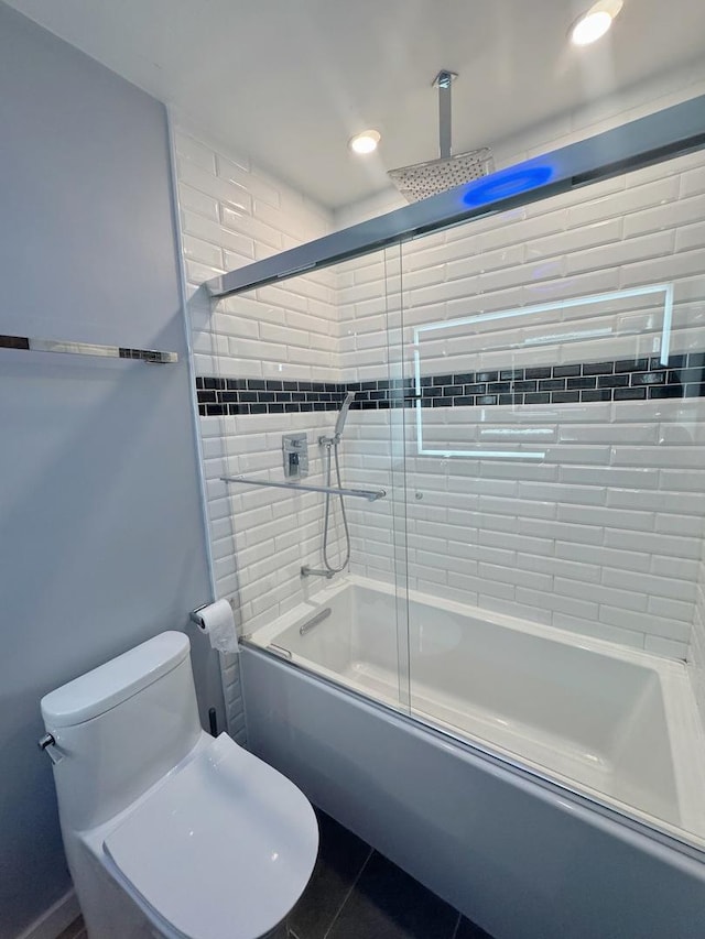 bathroom with bath / shower combo with glass door and toilet