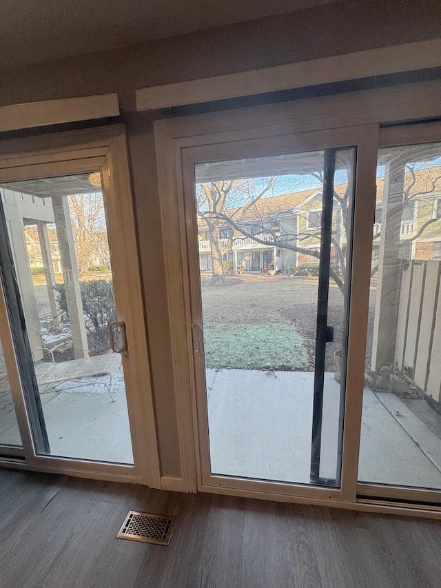 doorway with dark hardwood / wood-style flooring