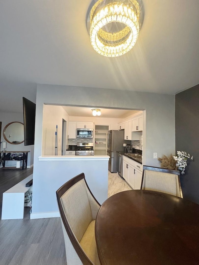 dining area featuring light wood-type flooring