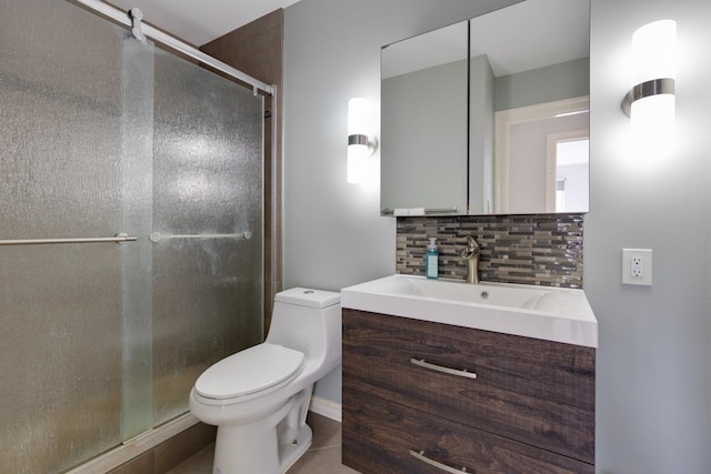 full bathroom featuring a stall shower, vanity, toilet, and decorative backsplash