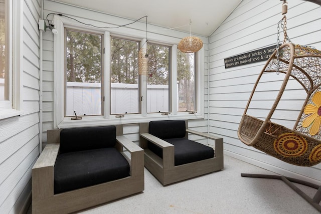 sunroom featuring vaulted ceiling