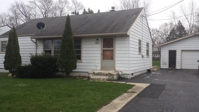 view of front of property with a garage and a front lawn