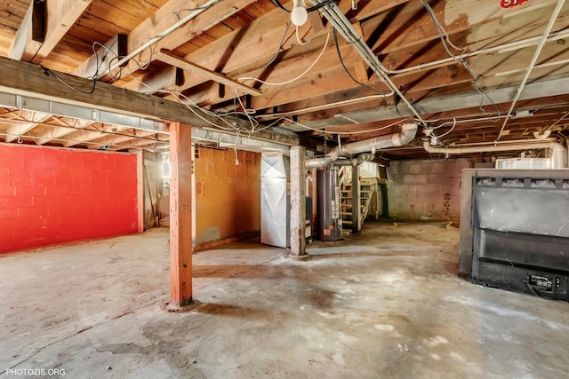 basement featuring gas water heater and heating unit